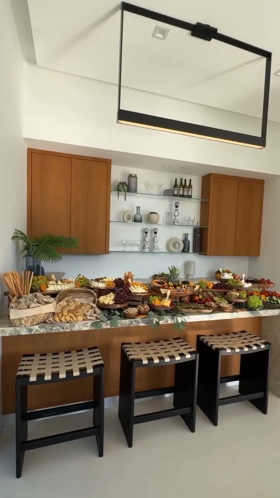 Long grazing table with cheese, fruit, and crudité