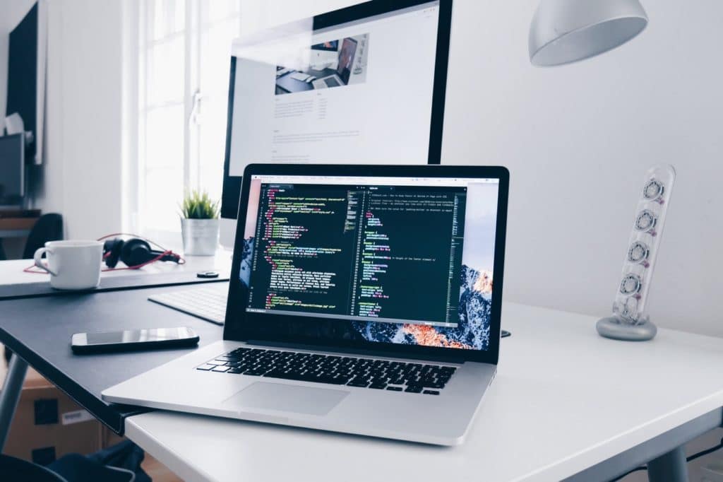 computer laptop on desk with html visible