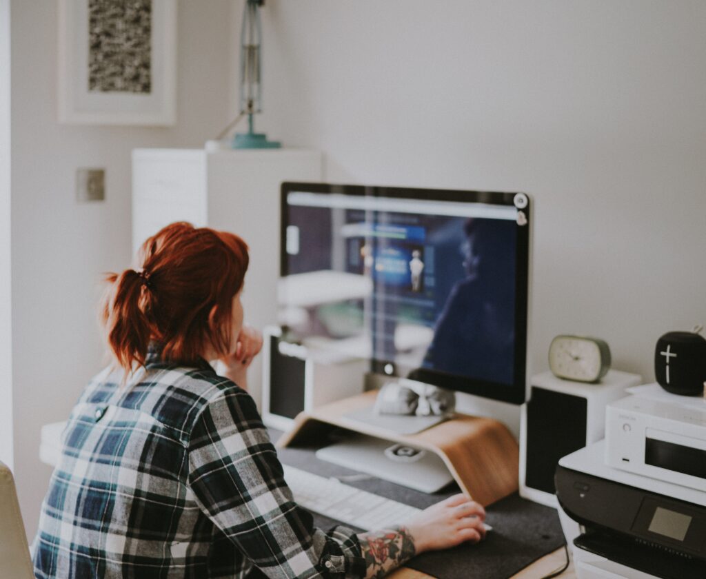 Woman clicking through a very optimized website for conversions. She looks engaged and focused on making a purchase.